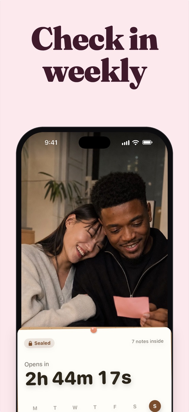 Check in weekly: a couple on the sofa, she rests on his shoulder while he reads her pink sticky note, above a sealed board counting down